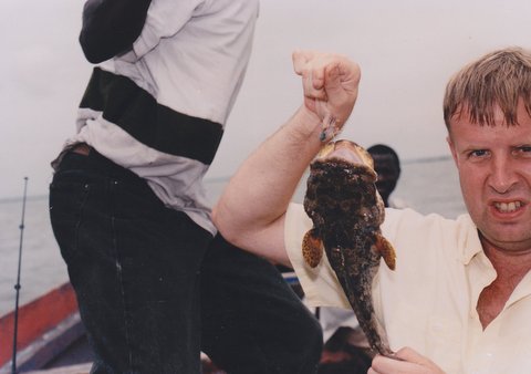 Файл:Anlging in Gambia man with a fish.jpg