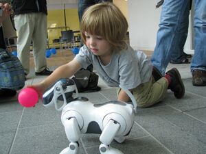 AIBO ERS-7 following pink ball held by child.jpg