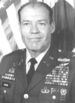 A black-and-white photo of older balding white man in his dress military uniform without a hat