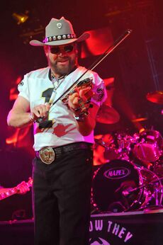 Hank Williams Jr playing a violin