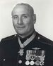 A black and white image of Howard wearing his dress blue uniform with medals and no hat. His Medal of honor can be seen around his neck and he is turned slightly to the left.