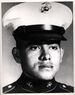 A black and white headshot of Jiminez wearing his military dress blue uniform with hat. He is looking slightly to the right.