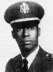 A black and white head shot image of Warren in his military dress uniform with hat.