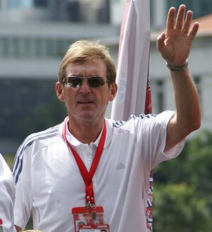 Man in a white shirt, wearing sunglasses.