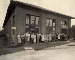 A group of people in front of a building